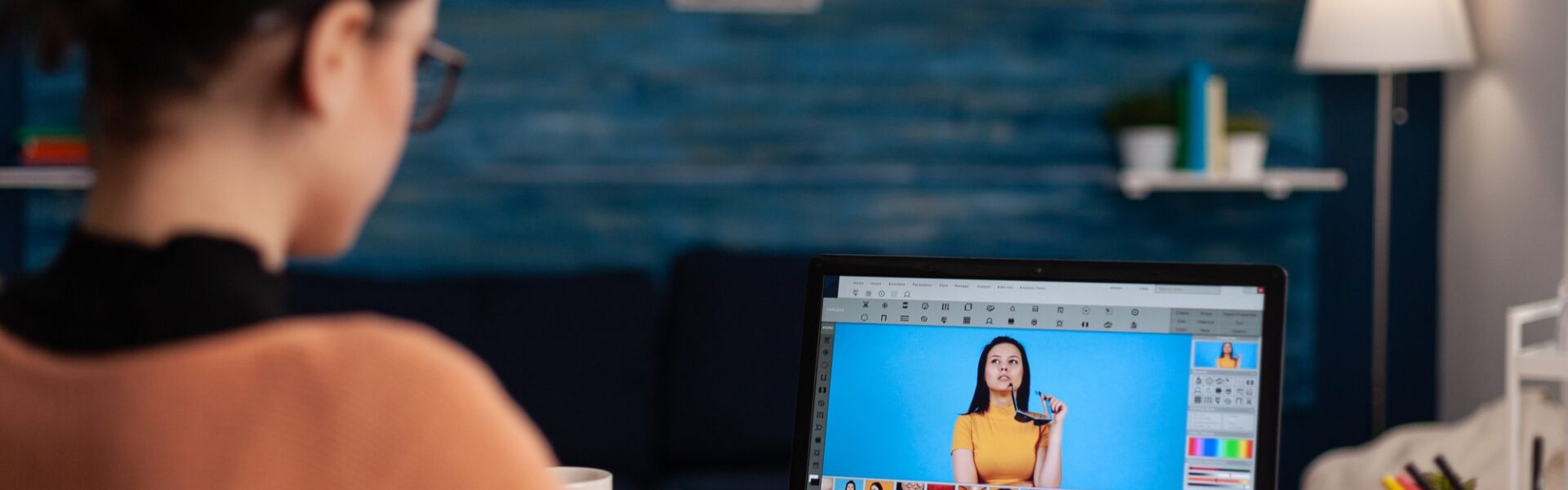 Student retouching photos on laptop