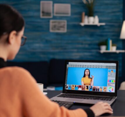 Student retouching photos on laptop