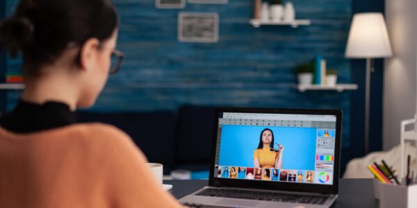 Student retouching photos on laptop